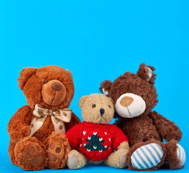 three teddy bears on a blue background, friendship concept, close up